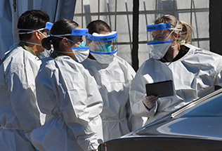 Doctors standing with masks and face shields
